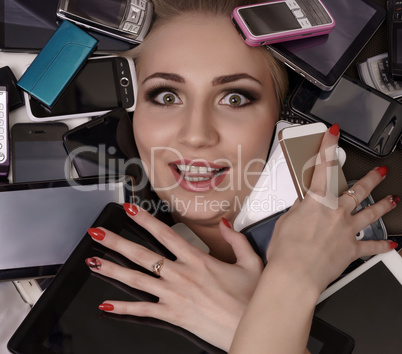 Digital madness. Stunned girl with smartphones