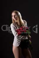 Sexy barelegged model posing with rose bouquet