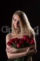 Nice topless girl posing with bouquet of red roses