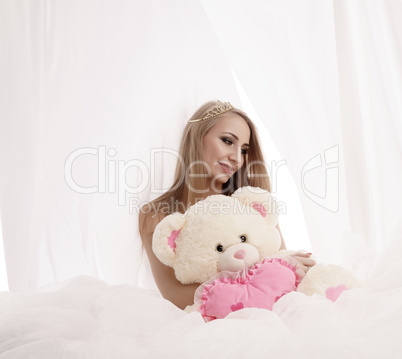 Beauty queen posing with plush teddy bear