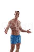 Bodybuilding. Smiling athlete throws up his hands