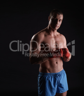 Sportsman with hand bandages, isolated on black