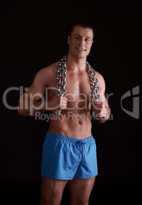 Image of strength athlete posing with chain