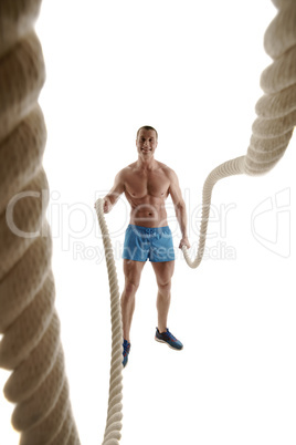 Studio shot of cheerful athlete with ropes