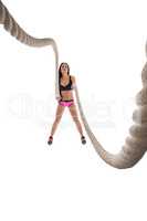Studio photo of sporty woman training with rope