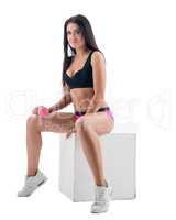 Training with dumbbells. Attractive model posing