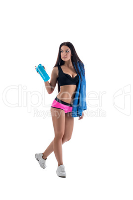 Pretty sportswoman posing with towel and shaker