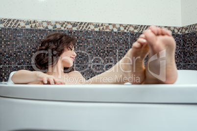 Image of dreamy brunette taking bath