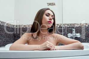 Bathroom. Portrait of nice brunette taking bath