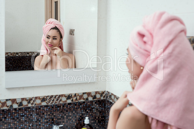 Reflection in mirror of sexy coquette after shower