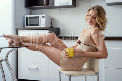 Curly blonde in negligee posing while drinking tea