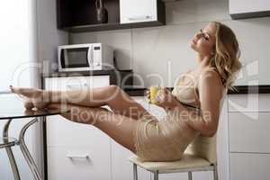 Lovely woman in negligee enjoying morning drink