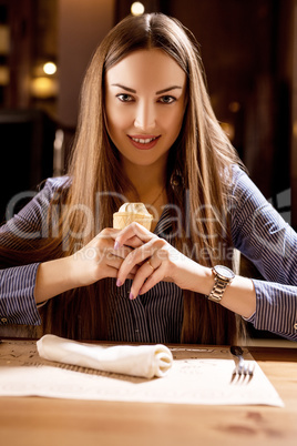 Stylishly dressed brunette posing with ice cream