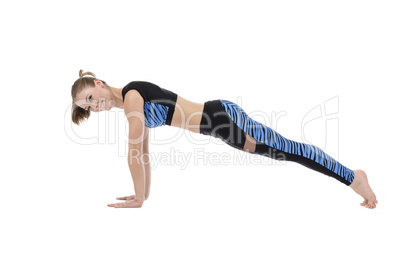 Studio image of pretty smiling girl doing push-ups