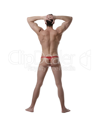 Striptease. Back view of muscular man in thong