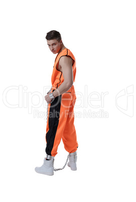 Bad guy posing in prison uniform and handcuffs
