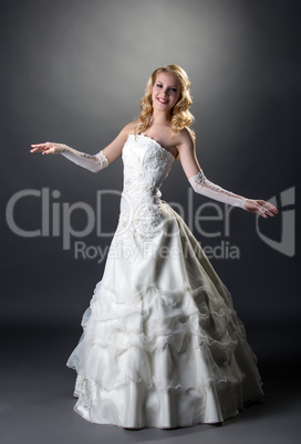 Blonde posing in wedding dress with embroidery