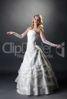 Blonde posing in wedding dress with embroidery