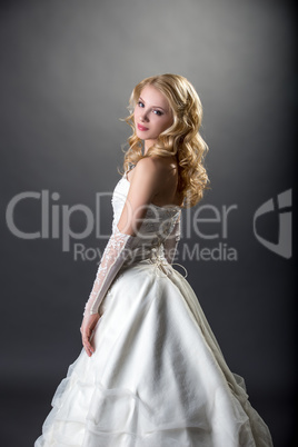 Pretty girl posing in beautiful wedding dress