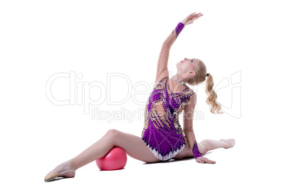 Graceful female gymnast performs with ball