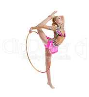 Flexible gymnast dancing with hoop in studio