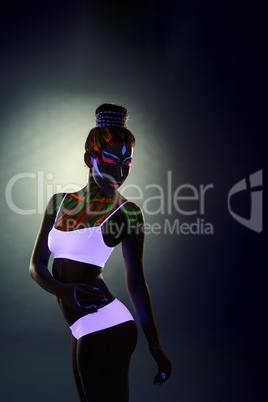 Sexy dancer posing with neon bodyart in studio