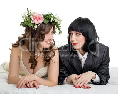Studio photo of girls dressed as bride and groom