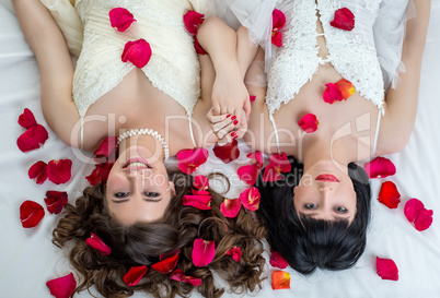 Top view of two charming brides looking at camera