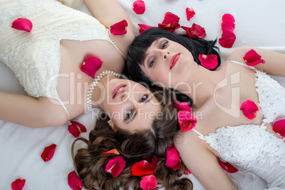 Top view of beautiful dark-haired brides lying