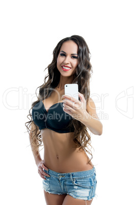 Smiling brunette doing photo on her smartphone