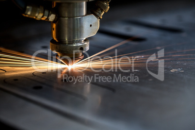 Cutting of metal. Sparks fly from laser