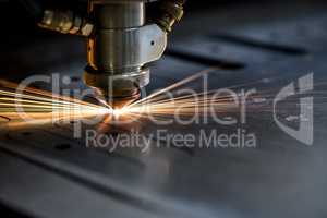 Cutting of metal. Sparks fly from laser