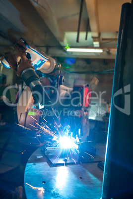 Image of robotic machine welding metal fasteners