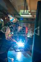 Image of robotic machine welding metal fasteners