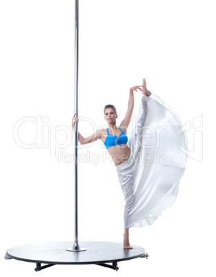 Cute dancer posing in vertical split on pylon