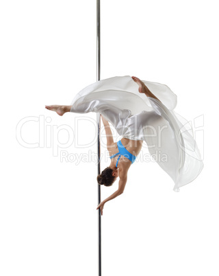 Graceful pole dancer posing in difficult turn