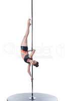 Shot of strong dancer posing upside down on pole