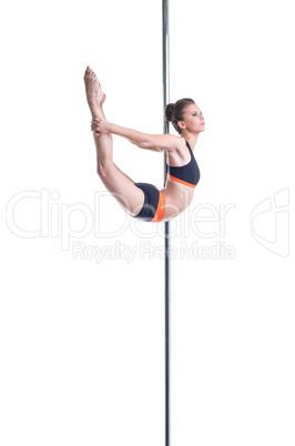 Pole dance. Sexy dancer performs complex trick