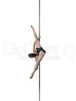Studio shot of flexible girl dancing on pole
