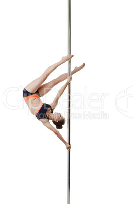 Petite dancer posing upside down on pole