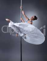Pole dance. Pretty dancer posing in elegant pose