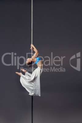 Sexy dancer bent gracefully while dancing on pylon