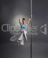 Lovely woman posing while dancing on pole