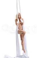 Image of nude model hanging on aerial silks