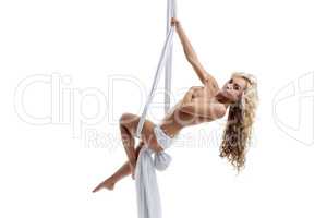 Flirtatious blonde posing topless on aerial swing