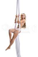 Shot of topless blond woman on aerial swing