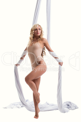 Graceful long-haired blonde posing on aerial silk