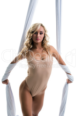 Aerial silk. Seductive blonde posing at camera