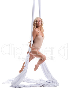 Elegant female dancer on aerial silk. Studio photo