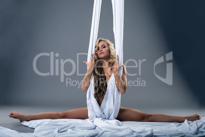 Image of naked blonde posing with aerial silks